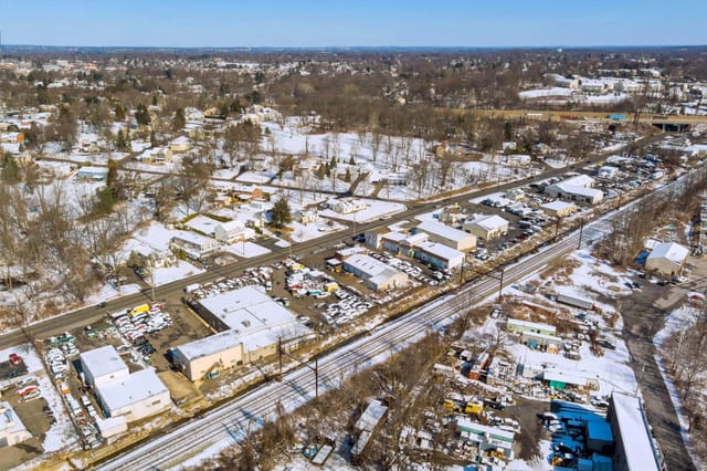 Snow-covered rooftops and streets in a residential area
